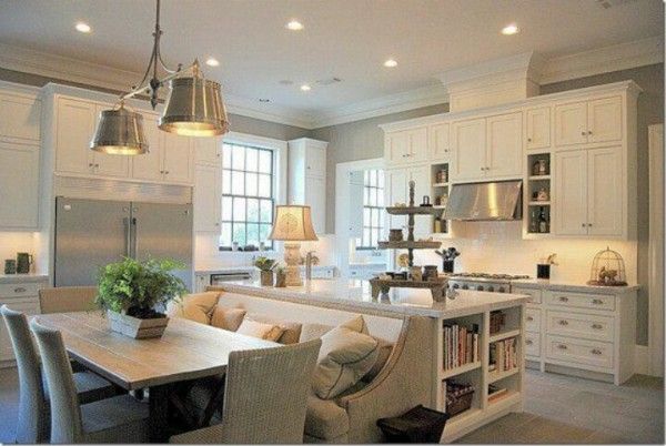 a large kitchen with white cabinets and an island