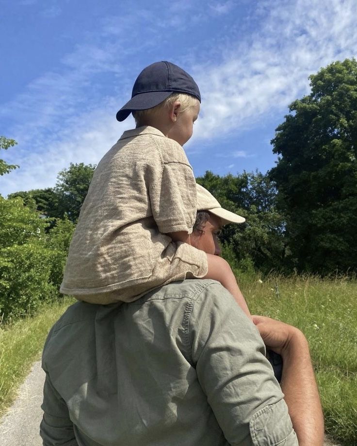 a man holding a small child on his back