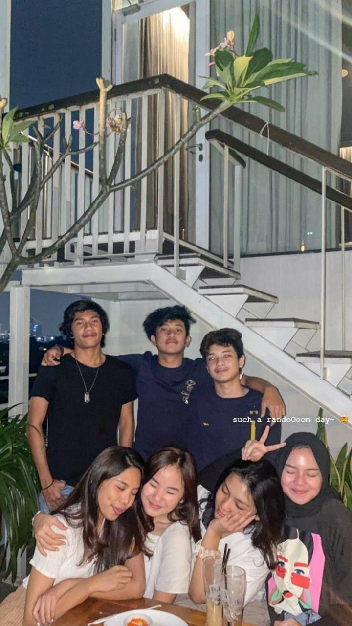 a group of people posing for a photo in front of some stairs