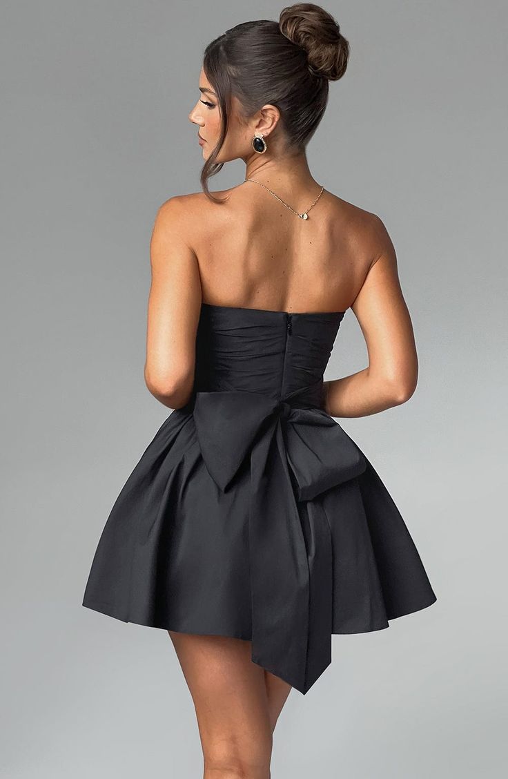 THE dress of the season has landed and you're going to be obsessed. Meet Katrina, our dreamy mini with a pretty, voluminous skirt and waist cinching bodice. Fastening with a zip to the back, tie with an oversized bow to complete the look for perfect feminine drama. 



Colour: Black.

Premium non-stretch cotton blend fabric.

Fully lined.

Strapless ruched bodice with boning.

Waist cinching.

Oversized tie to create bow detail to back.

Voluminous skirt with tulle lining.

Zip fastening to the Prom Mini Dress With Ruched Bodice, Elegant Dress With Voluminous Skirt For Night Out, Ruched Mini Length Bubble Dress For Evening, Ruched Mini Bubble Dress For Evening, Cocktail Mini Dress With Ruched Bodice Fit And Flare, Chic Ruched Bubble Dress For Parties, Chic Party Bubble Dress With Ruched Detail, Pleated Bodice Mini Dress For Prom, Evening Ruched Fit And Flare Mini Dress