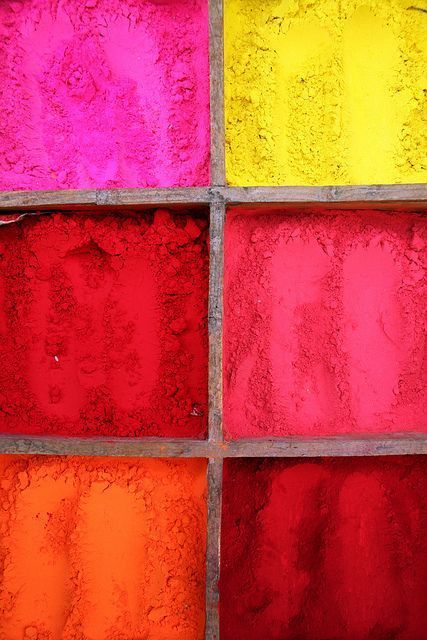 an image of colorful glass blocks in the process of being colored with colors that are red, yellow, pink, and orange