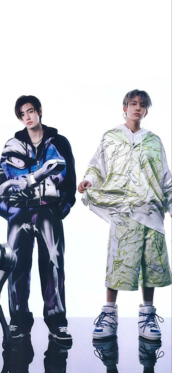 two young men standing next to each other in front of a white background wearing roller skates