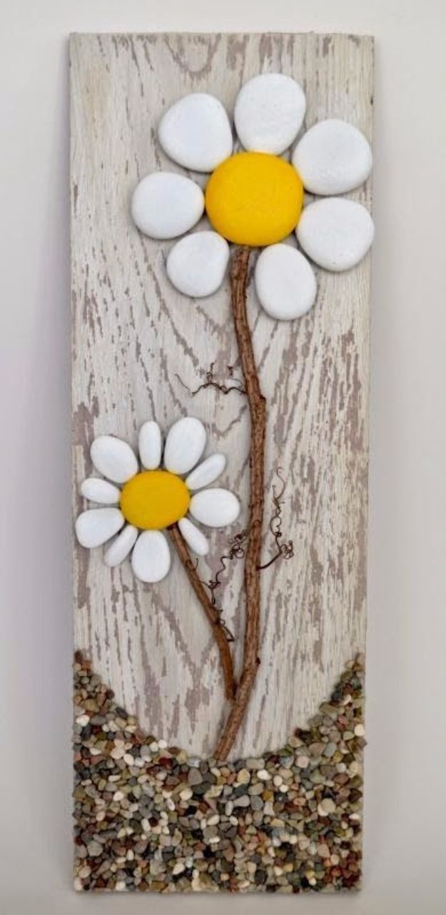 two white and yellow flowers on a wooden panel