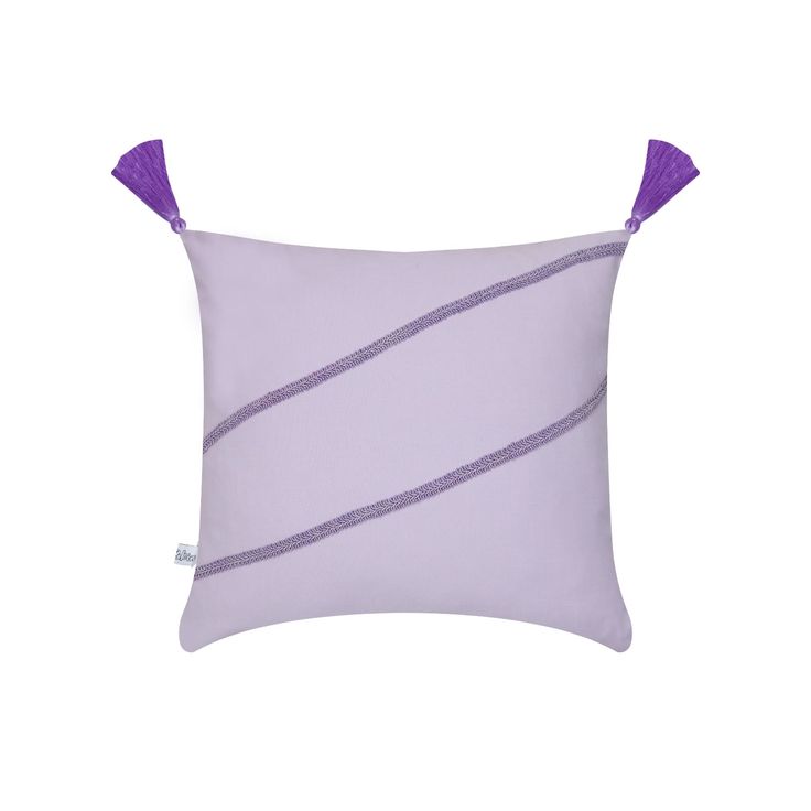 a purple pillow with two tassels on it