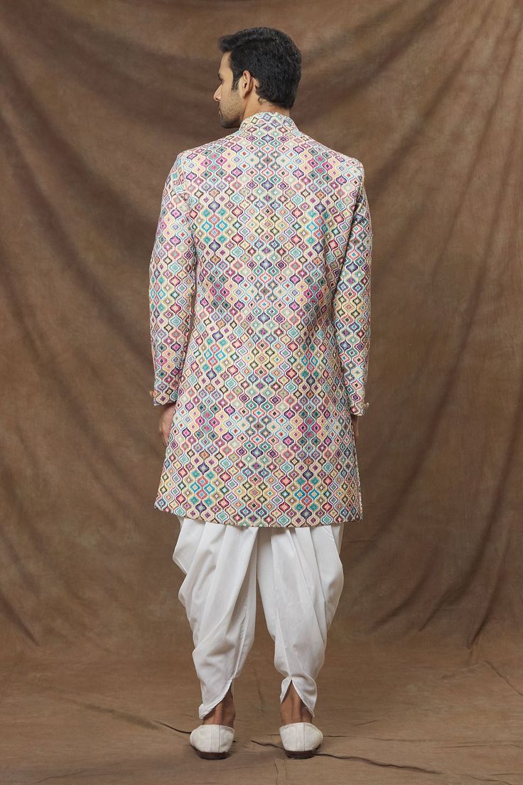 Multi colored straight sherwani in rayon base with abstract patterns and sequin spread. Comes with cowl pant.
Component: 2
Pattern: Embroidered
Type Of Work: Sequins
Neckline: Mandarin Collar
Sleeve Type: Full
Fabric: Sherwani: Rayon, Cowl Pant: Art Silk
Color: Multi Color
Other Details: 
Front button down 
Elasticated waistband with drawstring
Note: Pocket square worn by the model is not for sale
Occasion: Wedding - Aza Fashions Pant Art, Mandarin Collar, Pocket Square, Aza Fashion, Sleeve Type, Abstract Pattern, Multi Colored, Types Of Sleeves, Sequin