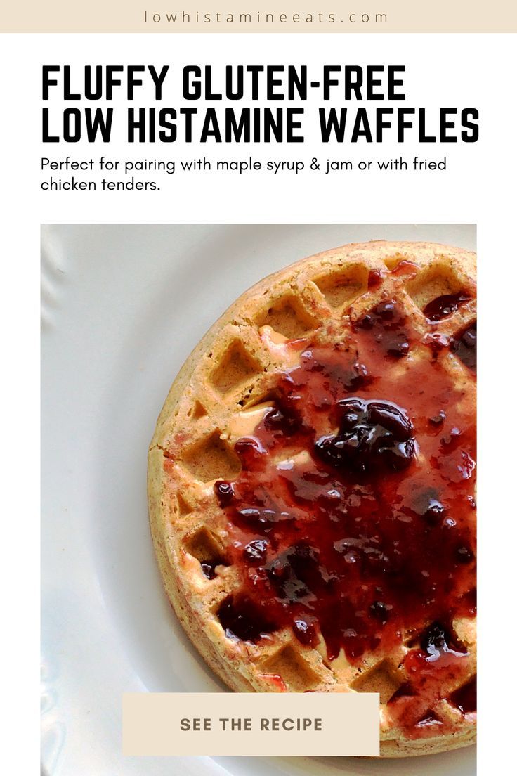 a white plate topped with a waffle covered in fruit and syrup next to a text overlay that reads fluffy gluten - free low histamine waffles