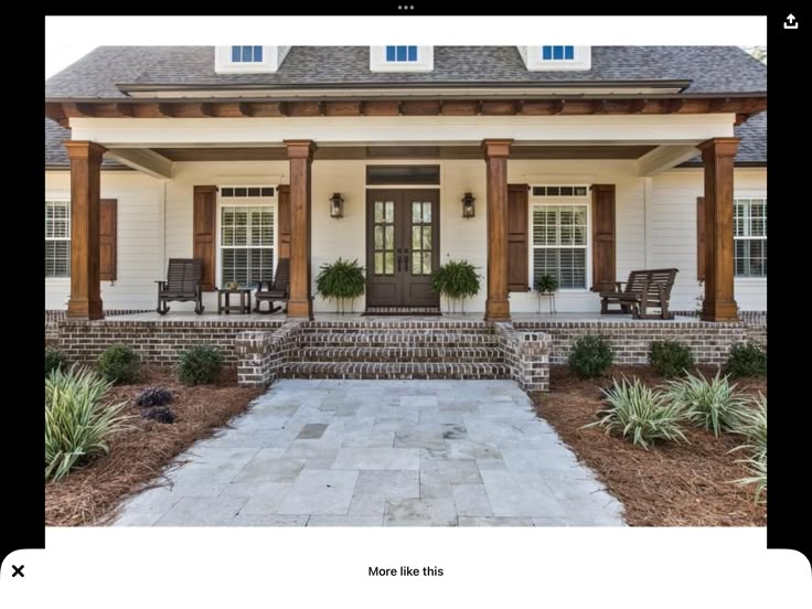 a white house with wood trim and columns