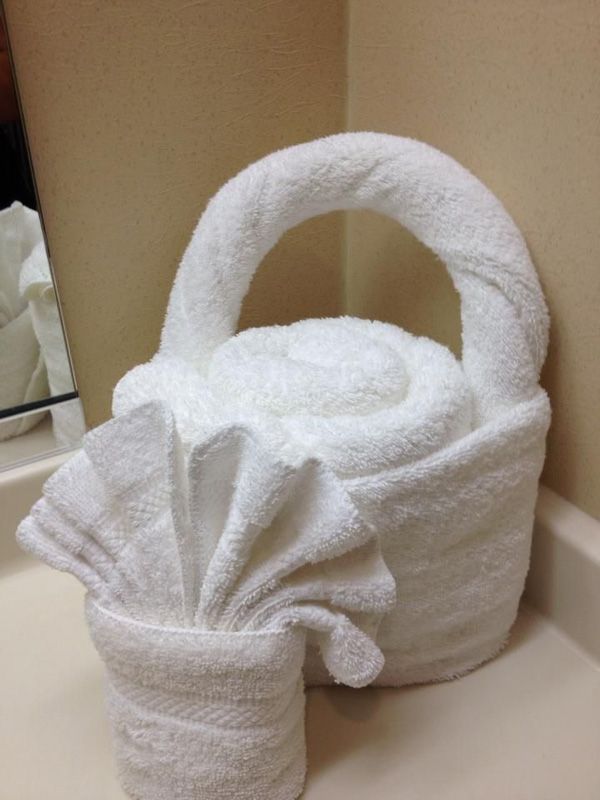 a white basket sitting on top of a bathroom counter