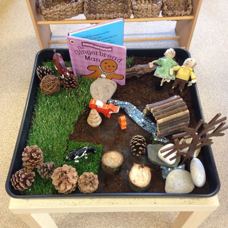 a table topped with lots of different types of toys and books on top of it