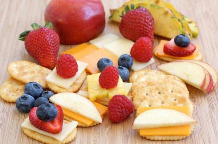 fruit and crackers are arranged on a table