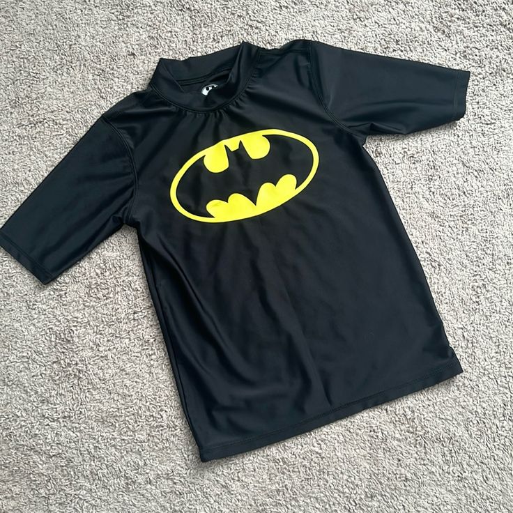 Nwot Batman Wash Guard Shirt. Size Large. Never Worn And In New Condition. My Kids Outgrew It Before They Had A Chance To Wear It. My Loss Is Your Gain! Short Sleeves And A Little Collar. Will Ship Quickly Smoke And Pet Free Home Playful Black Fitted Tops, Playful Fitted Black Tops, Black Crew Neck Tops For Playwear, Black Character Print Top For School, Fitted Character Print Tops For Playwear, Fitted Tops With Character Print For Playwear, Yellow Fitted School Top, Yellow Fitted Tops For School, Black Long Sleeve Tops For Playwear