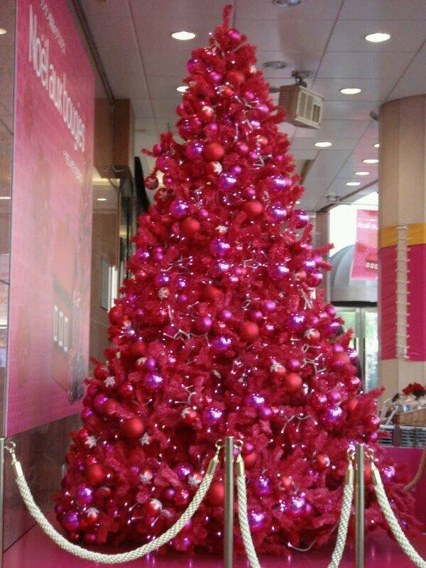 a large red christmas tree in the middle of a room