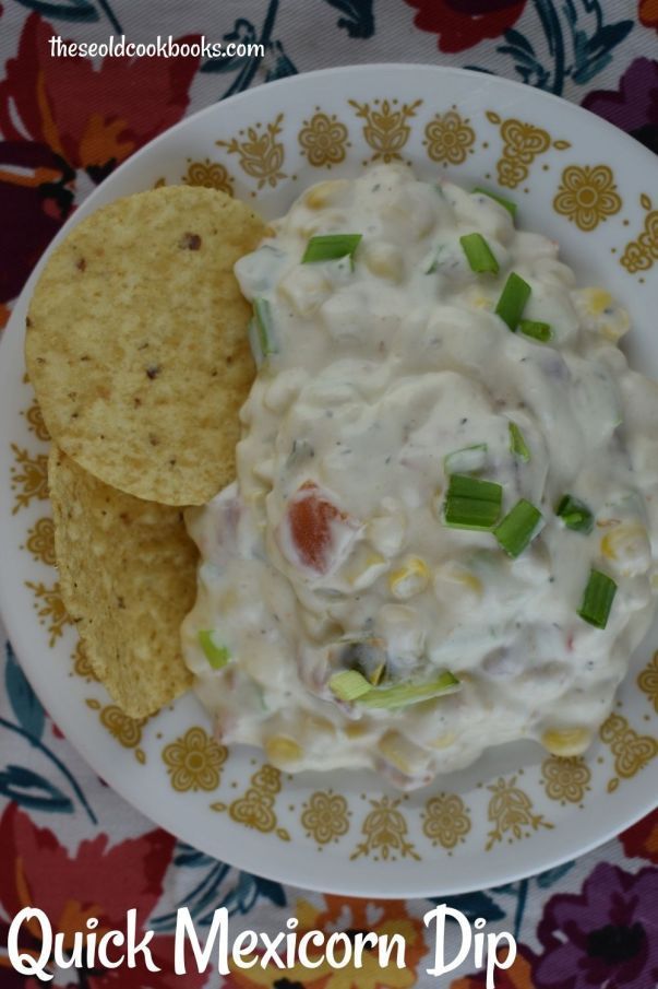 a white plate topped with chips and guacamole next to a cracker