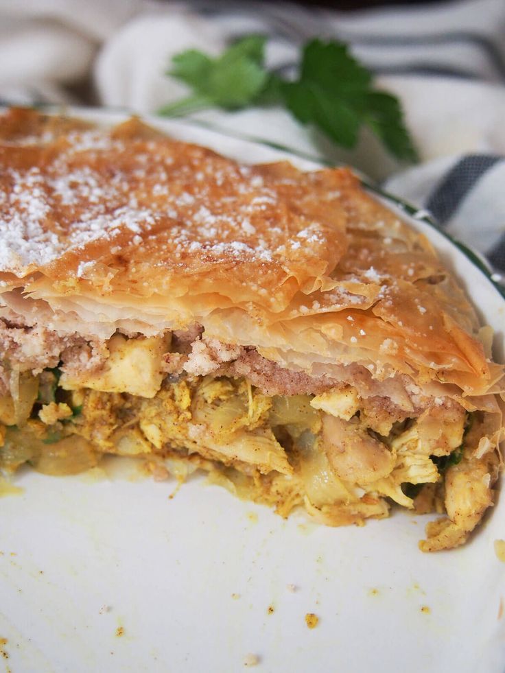 a piece of food that is sitting on a plate with some sort of crust in it