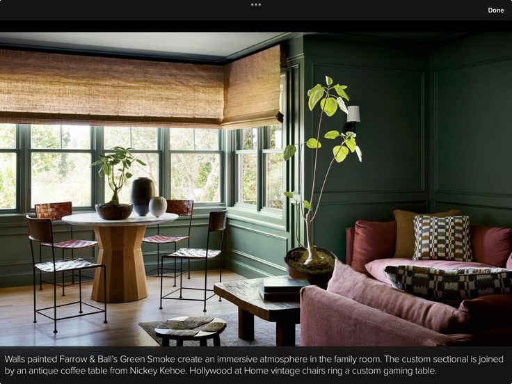 a living room with green walls and furniture