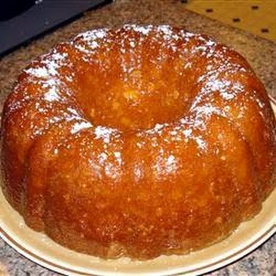 a bundt cake sitting on top of a white plate next to a microwave oven