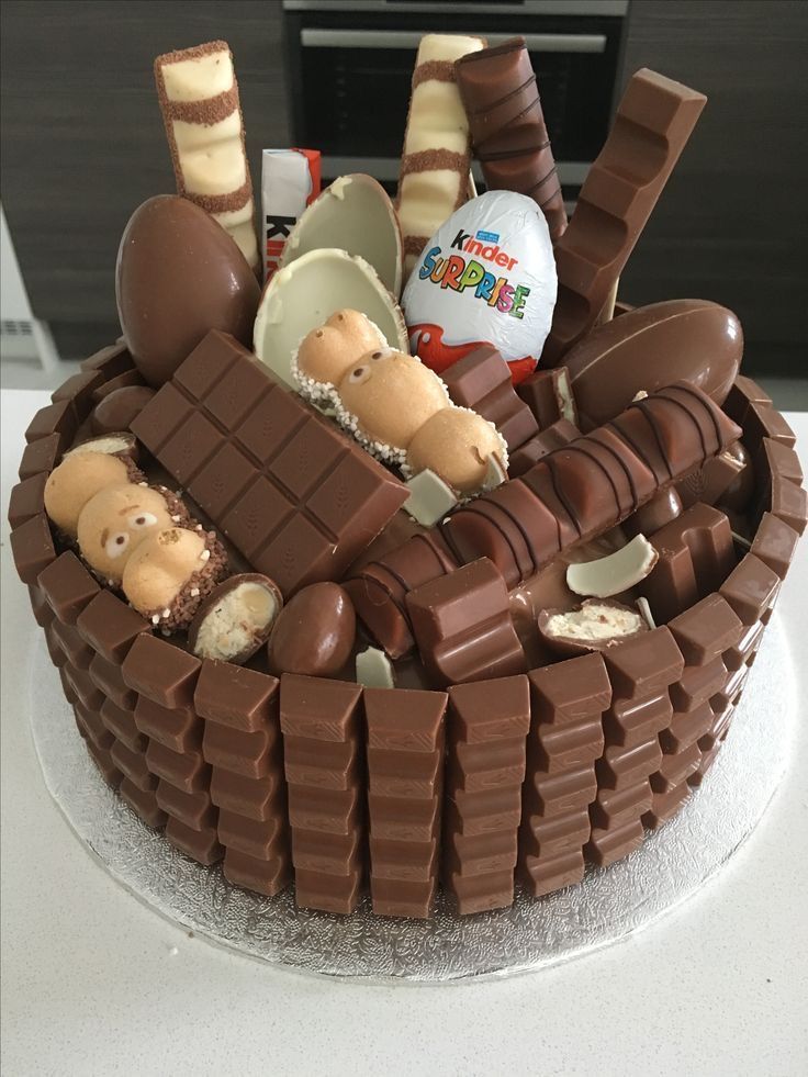 a chocolate cake decorated with teddy bears and baby items in it's back basket