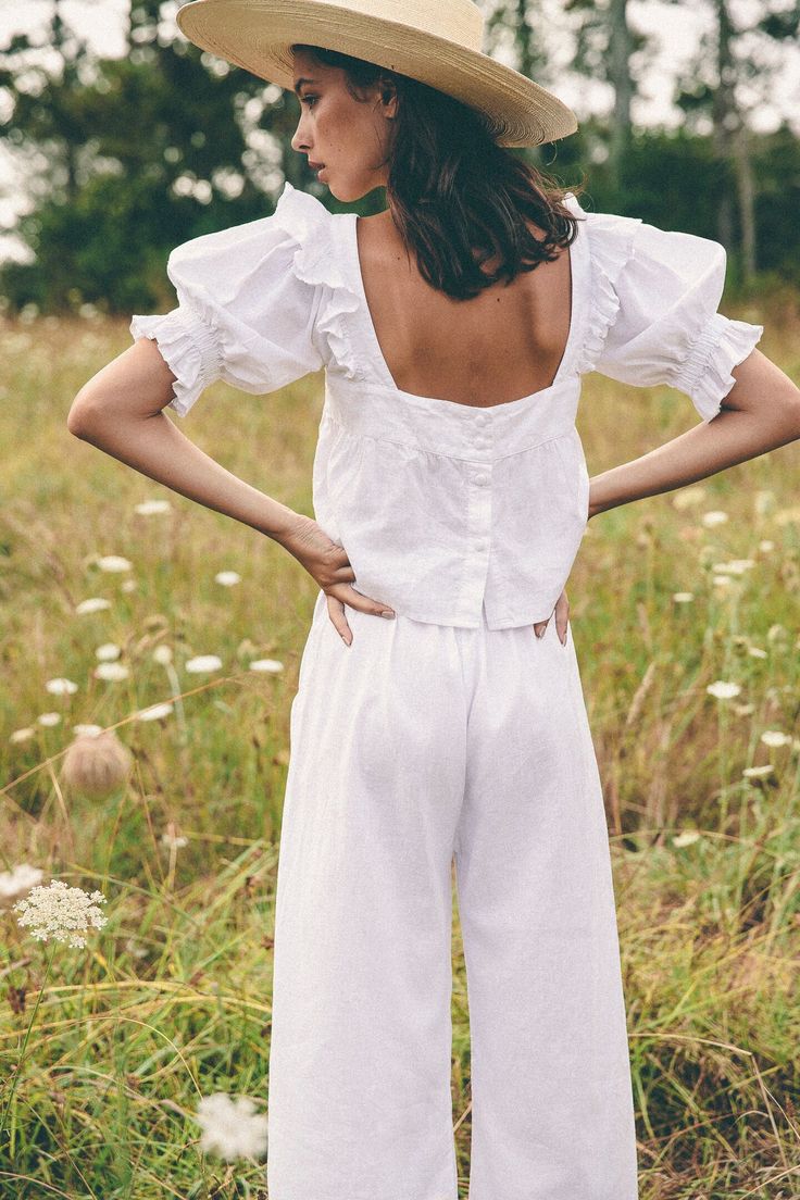 Introducing our name sake piece the Arden top, a playful take on a young girlish shape, featuring sweet ruffle details on oversized puff sleeves evoking feelings of fresh spring blooms with romantic notes, yet can easily be worn everyday. Made in cloud soft organic hemp that only gets better with time. Cut in a slightl Feminine Puff Sleeve Blouse For Garden Party, Summer Puff Sleeve Blouse For Garden Party, Feminine Ruffled Tops For Garden Party, Feminine Ruffle Tops For Garden Party, Billowy Cotton Top For Day Out, Feminine Puff Sleeve Tops For Garden Party, Spring Relaxed Fit Puff Sleeve Top With Ruffles, Spring Puff Sleeve Top With Ruffles And Relaxed Fit, Summer Cotton Puff Sleeve Top With Gathered Sleeves