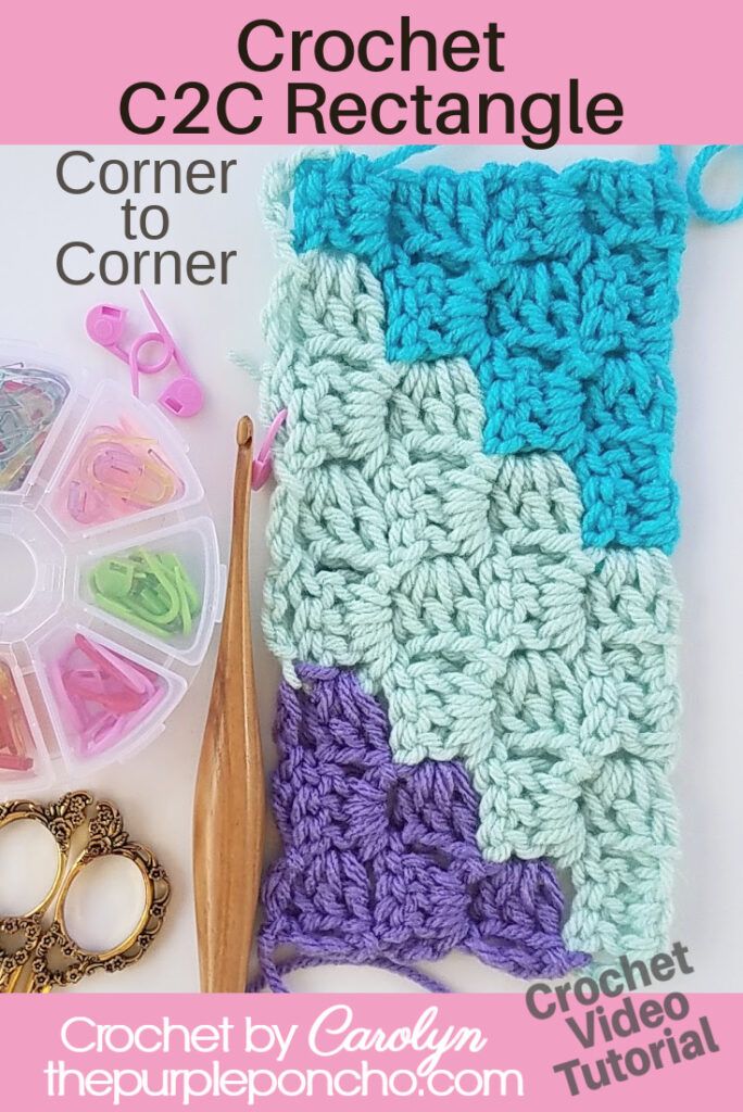 the crochet afghan is next to scissors, yarn and other crafting supplies