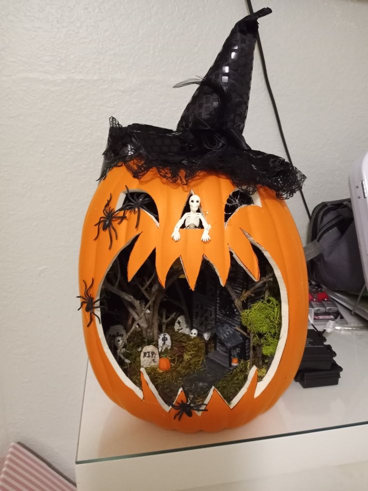 DIY project using craft pumpkin from Michael 's. Pumpkin Graveyard, Haunted House Pumpkin, Pumpkin Diaramas, Lego Pumpkin, Pumpkin Diorama, Halloween Fairy Garden, Halloween Pumpkin Diy, Light Up Pumpkins, Pumpkin Carving Contest