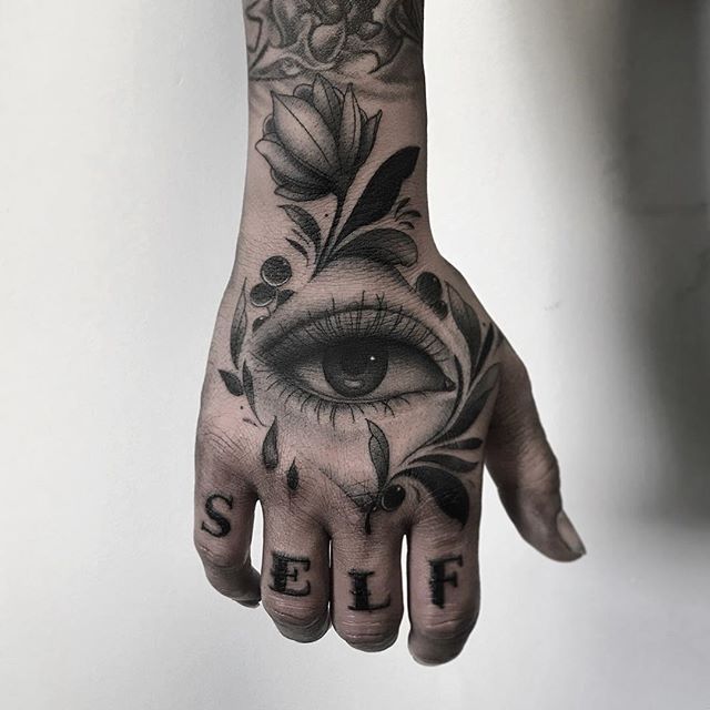 a hand with an eye and flowers on it