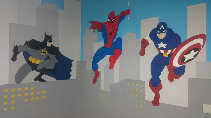 two superheros painted on the wall in a child's room with cityscape