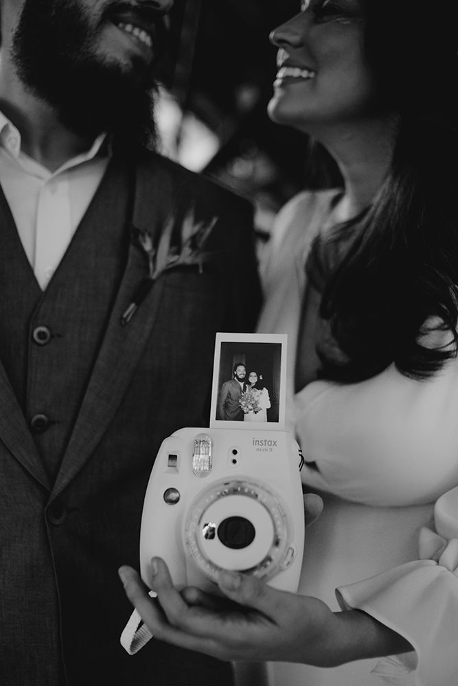 a man and woman holding up a camera