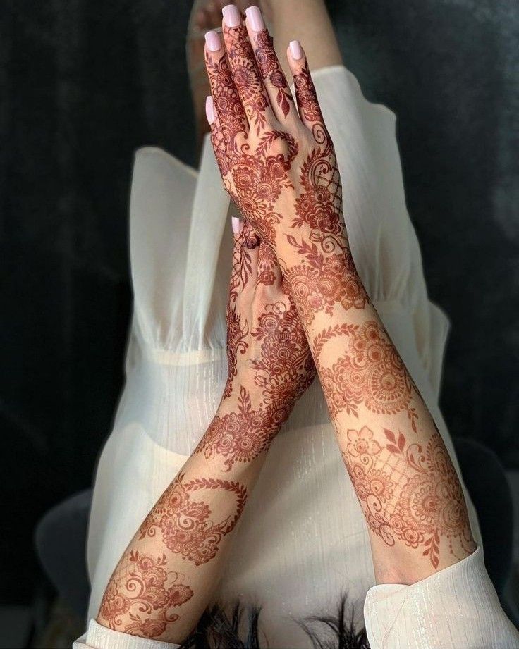 a woman with her hands covered in henna