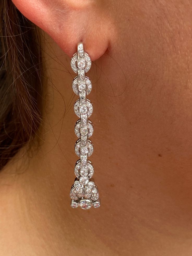 The Santa Rosa Outstanding Antique Platinum Dangler Earrings. The earrings feature a large old European cut center diamond at the lower part of the earring. On either side is a bezel set old euro with an interesting filigree pattern all set with diamonds about the bottom drop. A pattern of concentric circles set with diamonds and connected by a row of diamonds continues to climb up to the top where the earrings enter the ear. A larger center old European cut diamond is at the center of each circ Timeless Diamond Drop Earrings With 17 Jewels, Exquisite Pierced Diamond Earrings For Formal Occasions, Exquisite Diamond Pierced Earrings For Formal Occasions, Classic Diamond Drop Earrings With 17 Jewels, Elegant Platinum Diamond Earrings, Art Deco Diamond Earrings With Brilliant Cut, Art Deco Brilliant Cut Wedding Earrings, Timeless Pierced Diamond Earrings For Wedding, Art Deco Wedding Earrings With Brilliant Cut