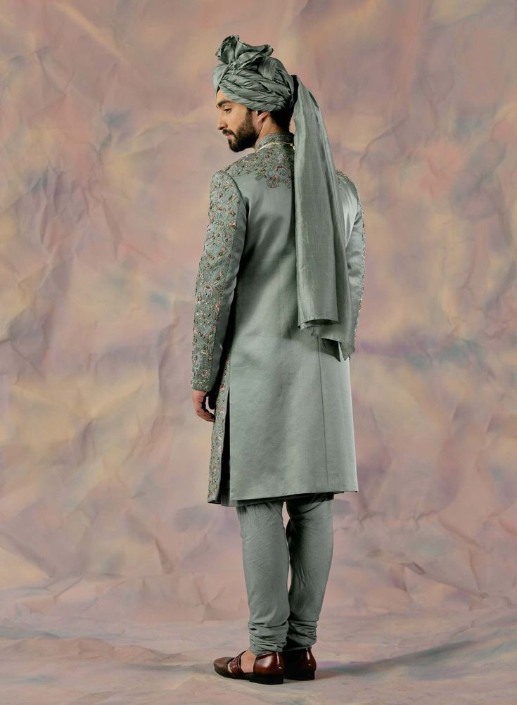 Editor's Note Featuring Heavy Hand Embroidered Sherwani With Applique Organza And Net Flower Details. Paired With Matching Safa, Pintuck Detailed Kurta And Churidar Fabric: Linen Silk Color: Grey Component: Sherwani, Kurta, Churidar, Safa Care: Dry Clean Only About the Designer After establishing himself as the leading couturier in the industry of menswear, Jatin Malik went on to explore luxury footwear. You can order online these amazingly designed handmade shoes that are being offered in class Jatin Malik, Gold Dupatta, Embroidered Sherwani, Dhoti Pants, Royal Look, Haldi Ceremony, Indian Man, Indian Wedding Outfits, Gray Linen