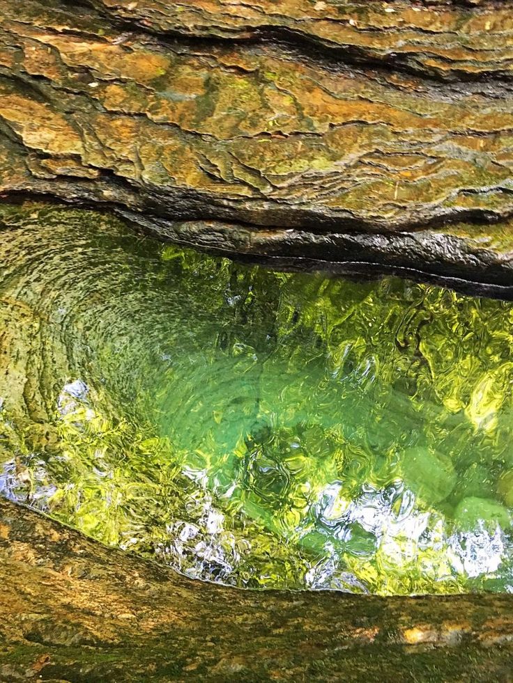 the water is green and clear in this cave