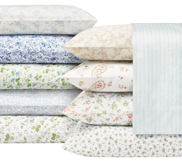 a stack of sheets and pillow cases with flowers on them