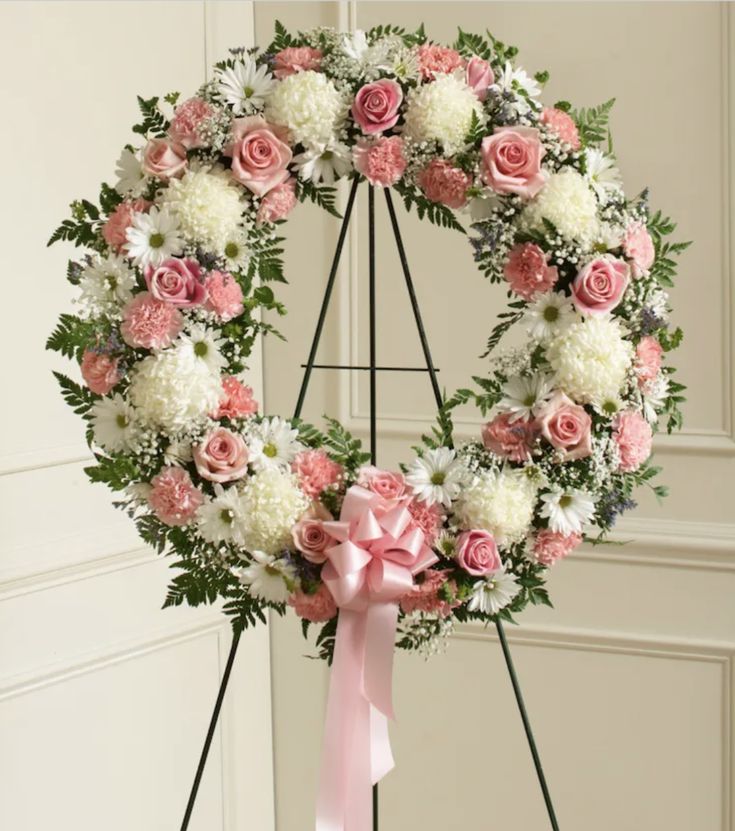 a wreath with pink and white flowers on it