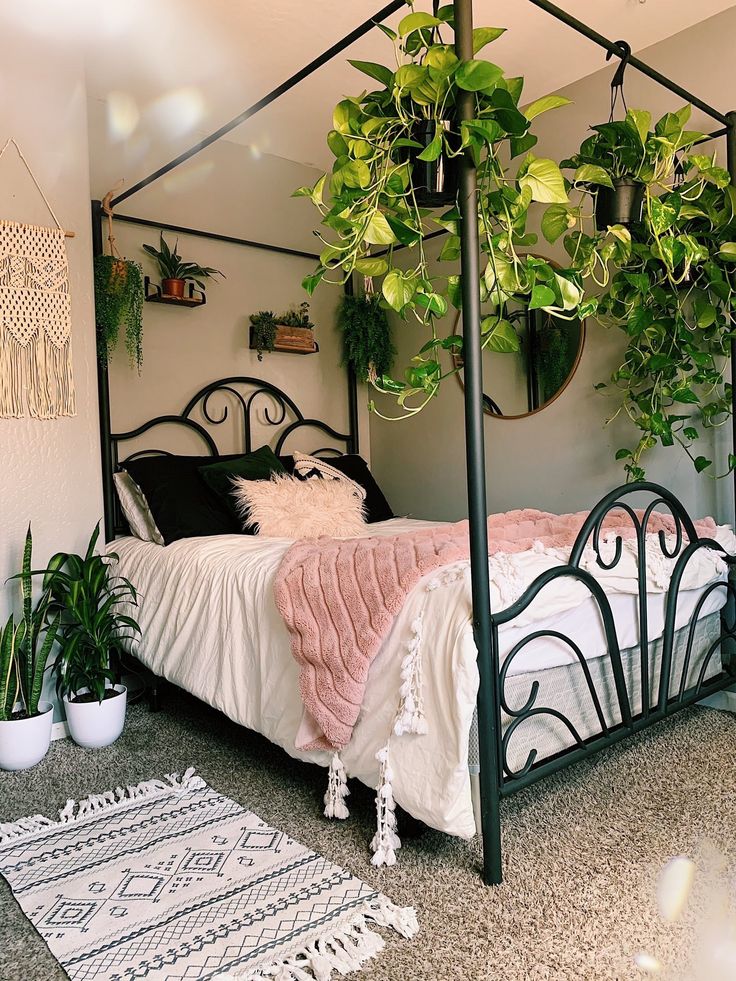 a bedroom with a bed, plants and rugs on the floor