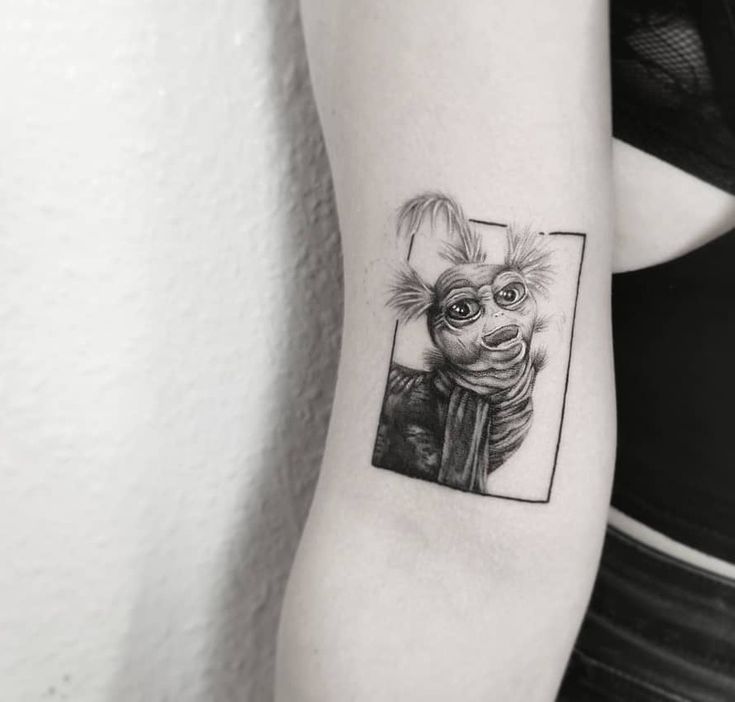 a woman's arm with a black and white drawing of a cat on it