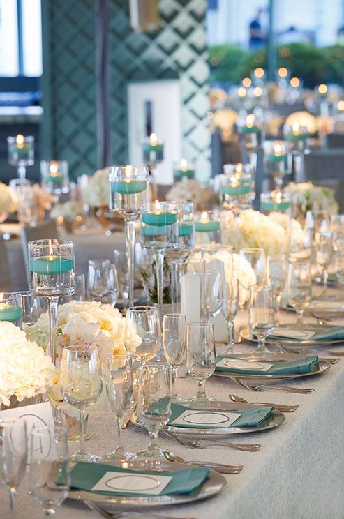 the table is set with many glasses and place settings for guests to sit down at