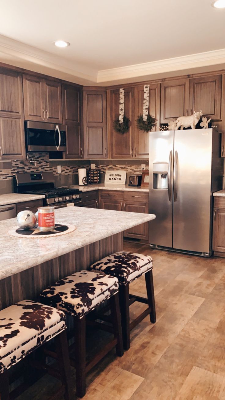 a kitchen with wooden cabinets and stainless steel appliances