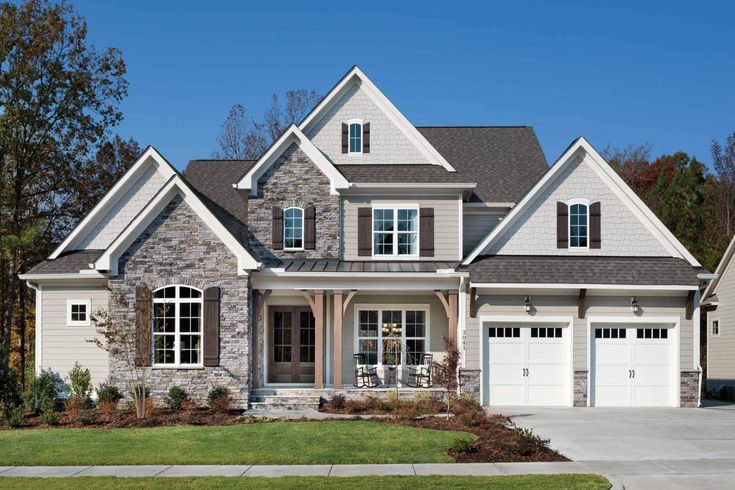 a large house with two garages in the front and one on the other side