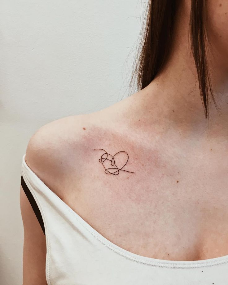 a woman with a small tattoo on her shoulder