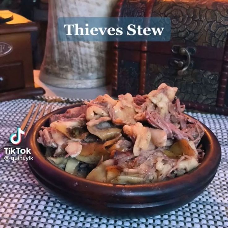 a bowl filled with meat sitting on top of a table