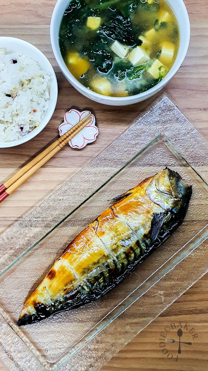 an image of food on the table with chopsticks and bowl of soup next to it