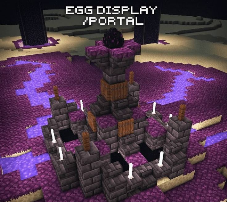 an egg display in minecraft with purple and black rocks on the ground next to it