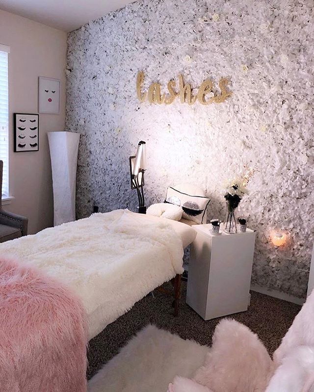 a bedroom decorated in white and pink fur with gold letters on the wall above it