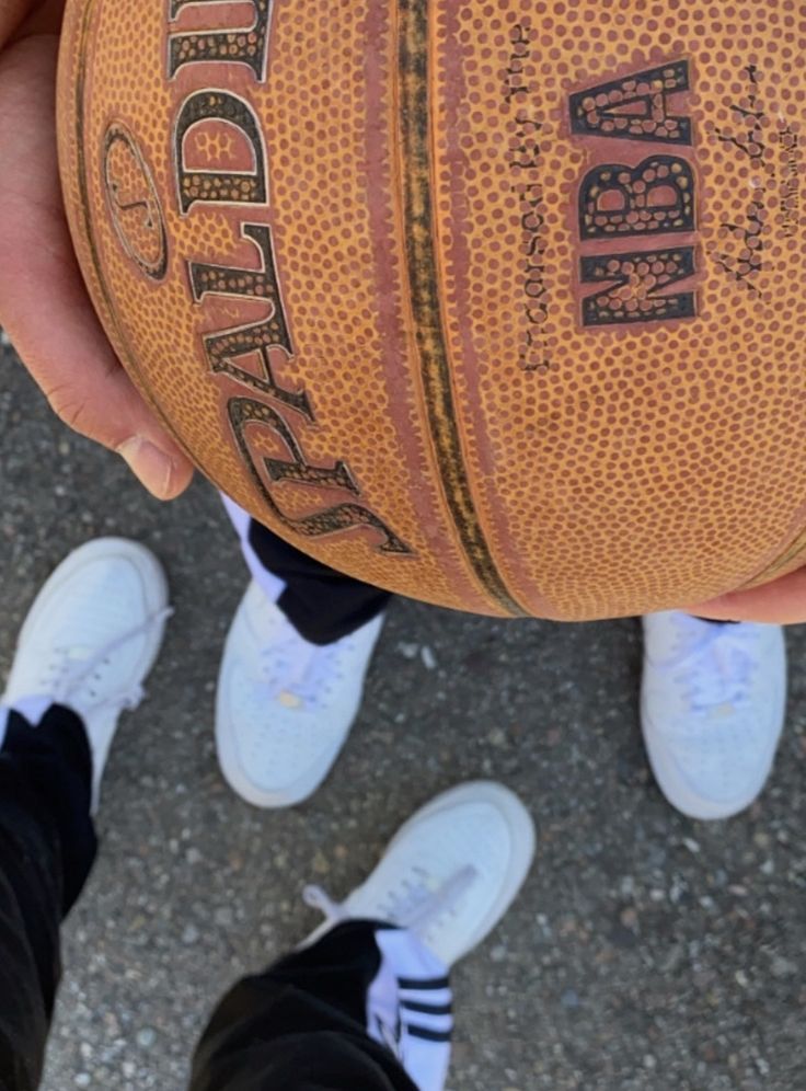 a person holding a basketball in their hands