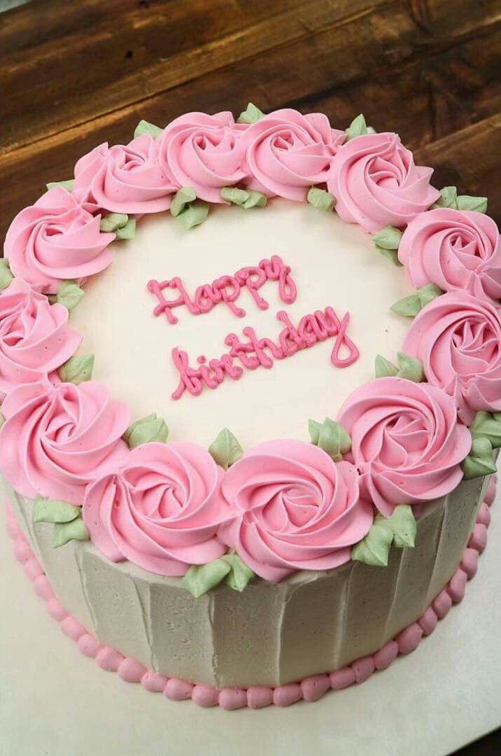 a birthday cake with pink frosting roses on it