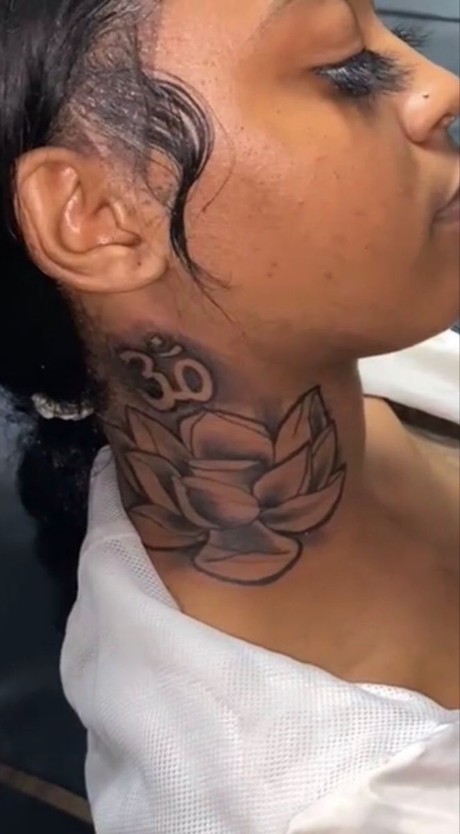 a woman with a tattoo on her neck