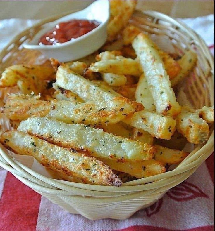 french fries in a basket with ketchup on the side