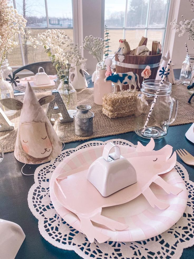 the table is set with plates, napkins and other items for an easter party