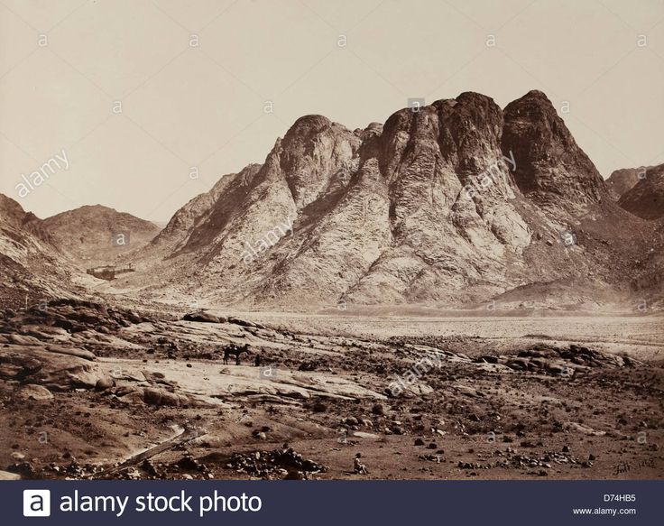 an old black and white photo of mountains in the desert with rocks on each side