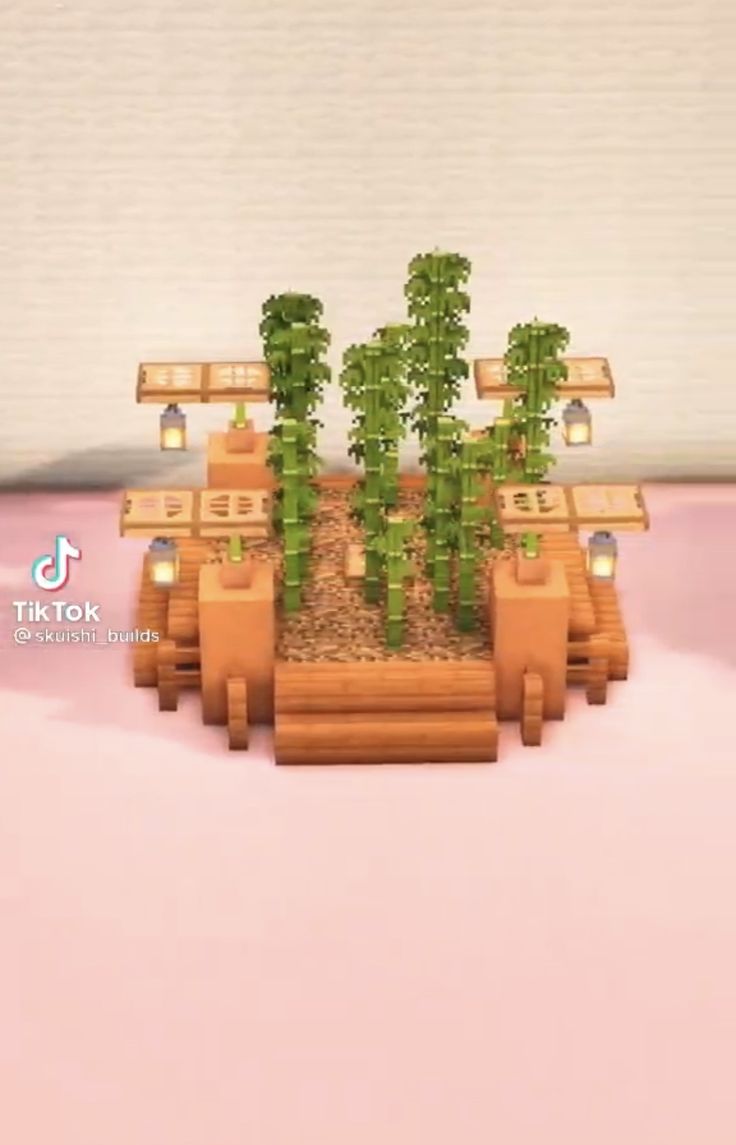 a small wooden planter with plants growing out of it's sides on a pink surface